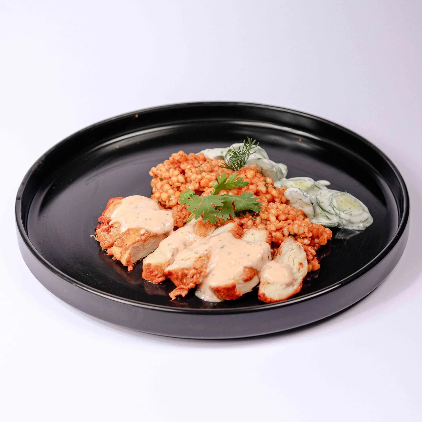 Harissa Chicken with Pearl Couscous & Cucumber Yogurt Salad